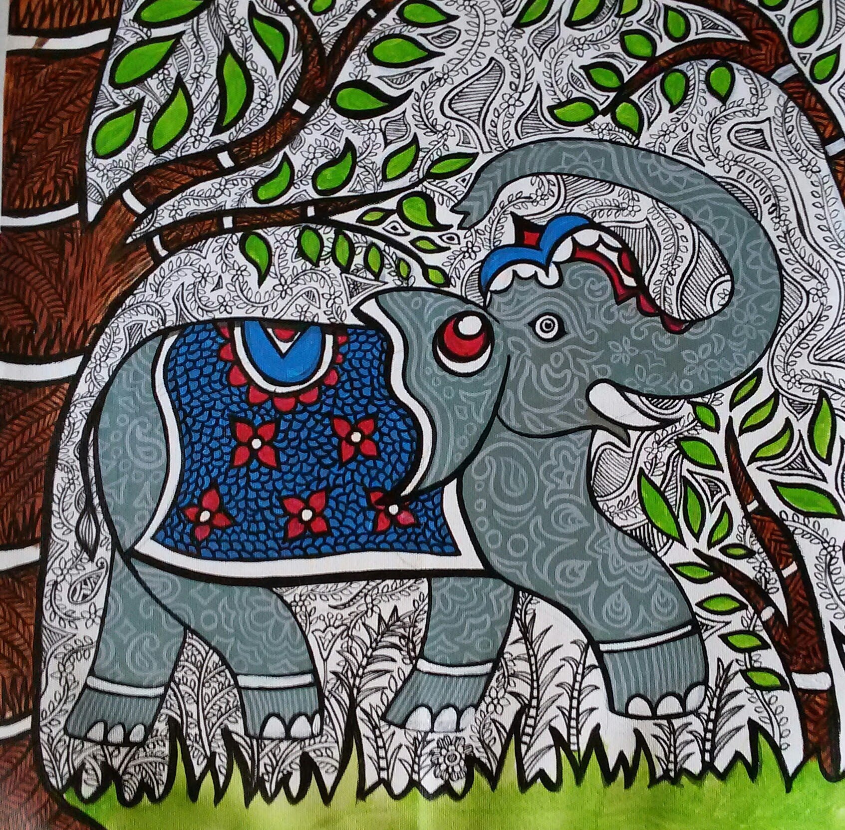 Grey patterned elephant walking beneath a leafy tree.